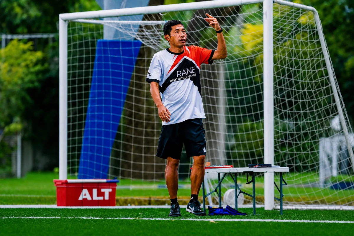 Coach Hafizat Jauharmi on a football pitch