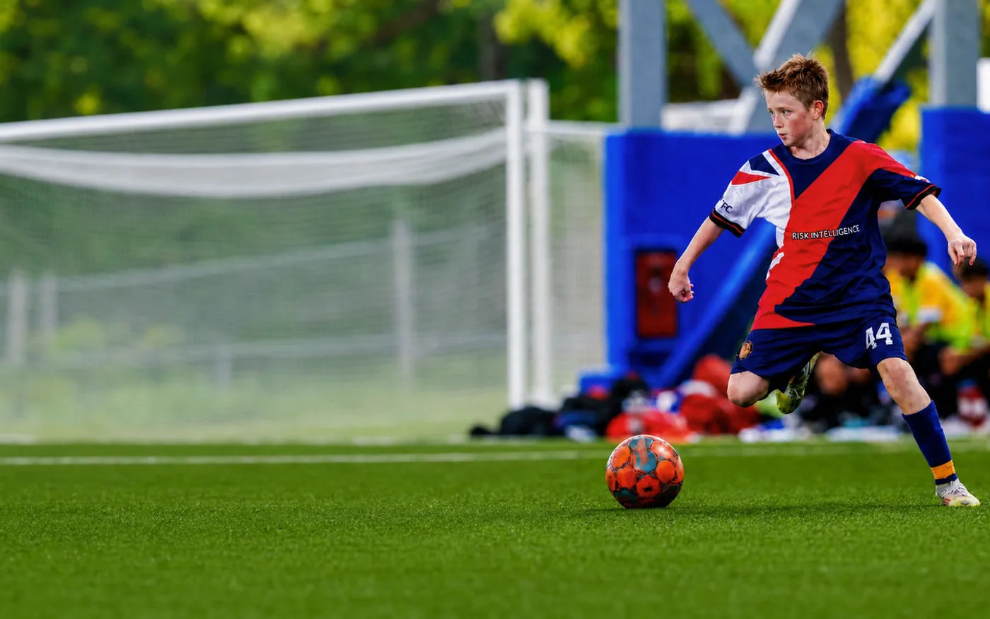 Island City Elite player dribbling the ball during a match