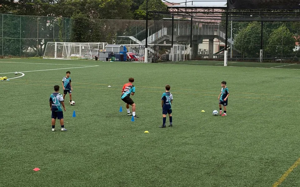 Coach giving individual technical feedback to a young footballer
